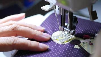 Lady uses sewing machine doing applique cloth work video