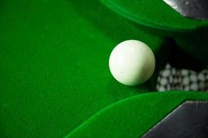 Snooker ball on the edge of the hole photo