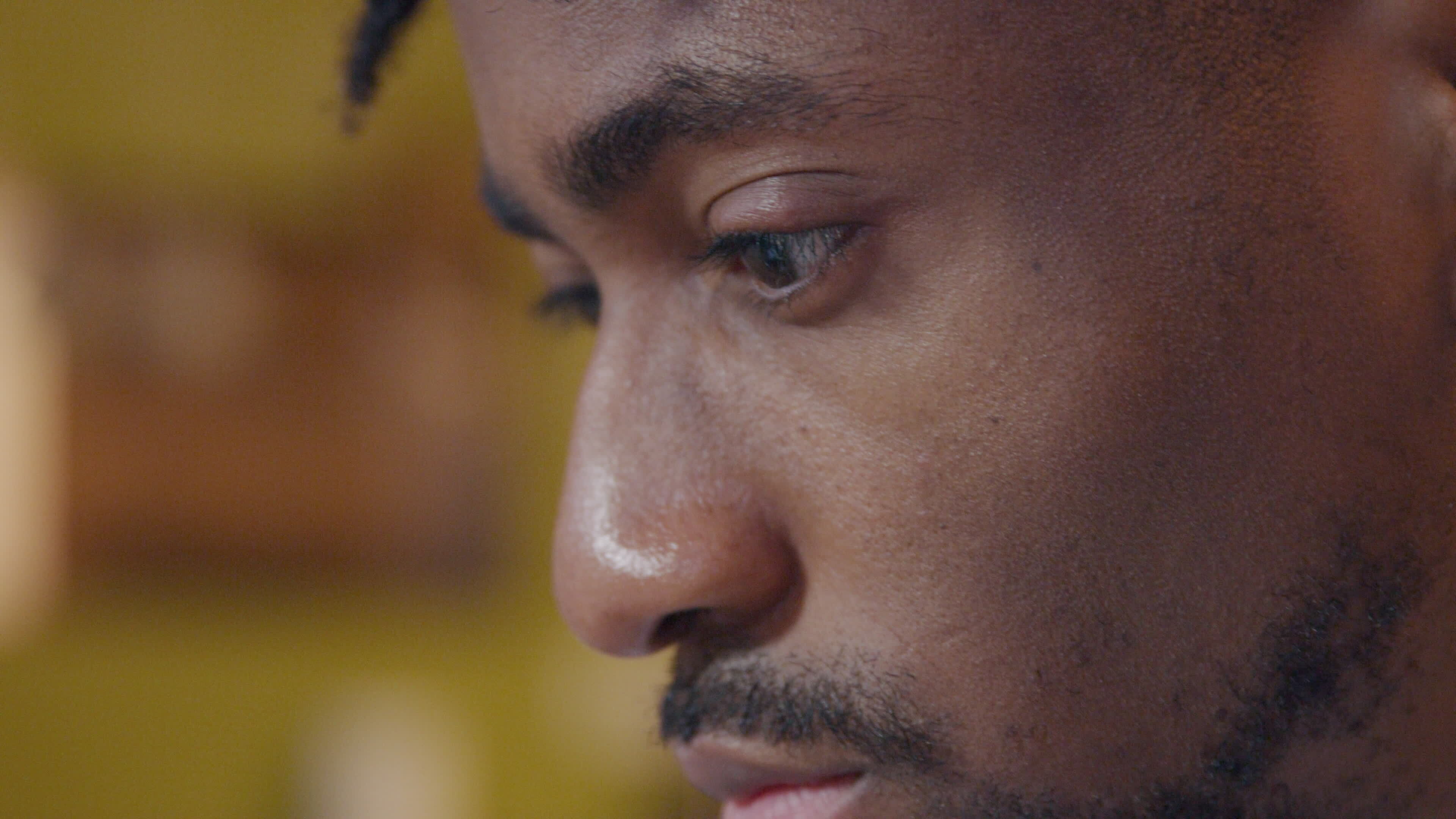 Close up of mature black man, eyes moving up and down slightly, head