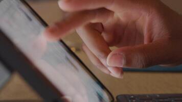 Close up of fingers of black mature man, scrolling on screen of laptop, tipping once on it. Blurred screen video