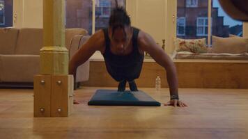 Black man practicing push ups on mat video