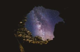 Starry sky from the inside of a cave photo