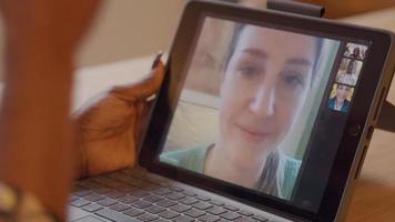 Close up of hands of woman, holding screen of laptop, and gesturing whilst having video call
