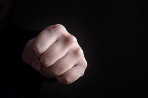Hand punch fist on black background