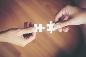 Hands holding jigsaw puzzles photo