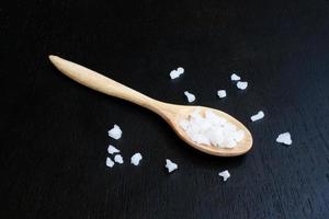 Salt on wooden spoon photo