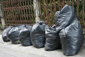 Row of trash bags outside photo