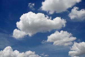 Fluffy white clouds in a blue sky photo