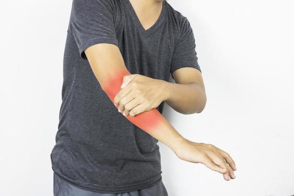 Man has arm pain and ache on white background photo.
