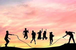 Silhouette of group people rope jumping