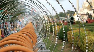 Fence topped with barbed wire photo