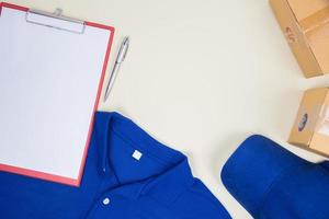 Top view of worker's shirt and postage boxes photo