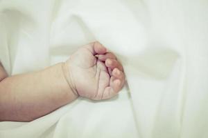 New born baby's hand with selective focus photo