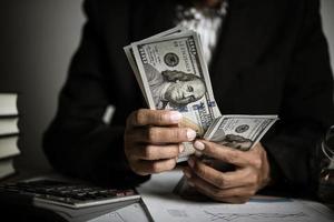 Hands of businesswoman holding money photo