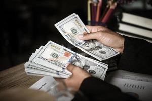 Hands of businesswoman holding money photo