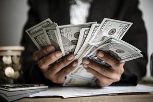 Hands of businesswoman holding money photo