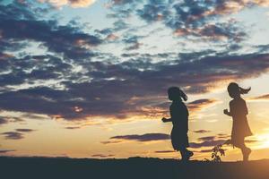 silueta de niños jugando al atardecer foto