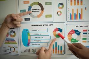 Business documents over papers with numbers and charts photo