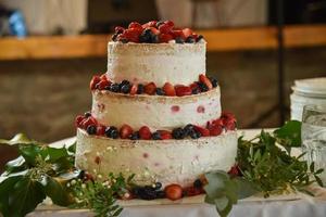 White cake with berries photo