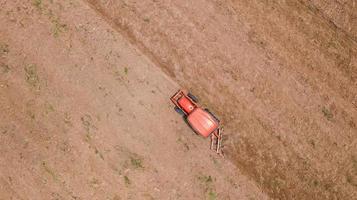Aerial view of a red tractor in a field photo