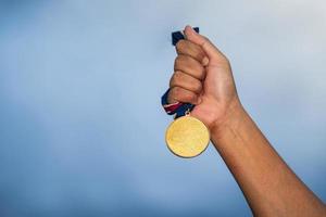 Person holding a medal photo