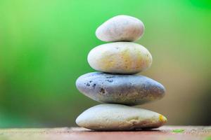 Zen stone on a green background photo