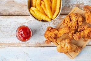 Top view of fried chicken and fries photo