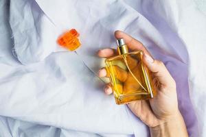 Person holding a perfume bottle photo