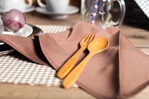 Wooden spoon and fork on the napkin photo