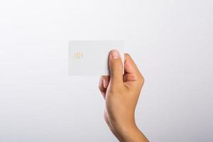 Close-up of woman holding a blank card isolated on white background photo