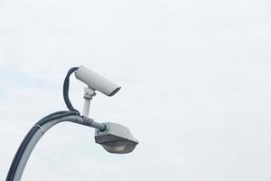 CCTV camera on a street lamp photo