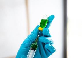Filling syringe with green liquid photo