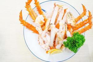 Red king crab legs with fresh lemon slices photo