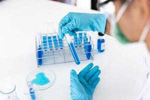 Scientist experimenting with test tubes photo