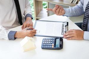 People filling out insurance forms photo