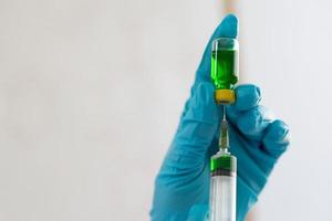 Filling a syringe with green liquid