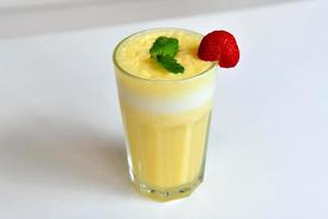 Yellow smoothie in a glass photo