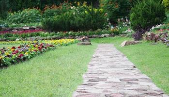 Stone pathway in a garden during the day photo