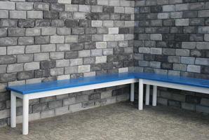 Brick wall and blue benches photo