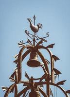 Cast-iron bell tower with a weathercock photo