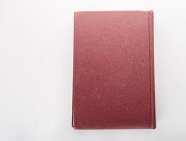Red leather notebook isolated on white background photo