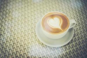 Latte art coffee with heart-shaped milk foam photo