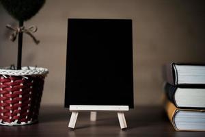 Small chalkboard and stack of books photo