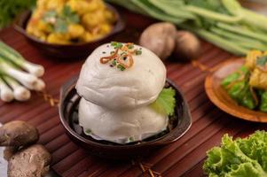 Steamed buns in a wooden dish photo