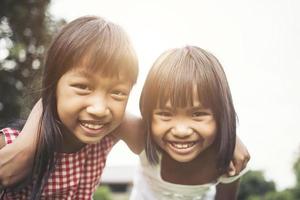 Two little girls having fun playing in the park photo