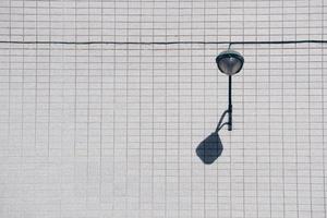 Street lamp on the wall in Bilbao City, Spain photo