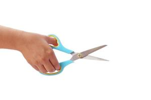 Hand is holding scissors isolated on a white background with the clipping path photo