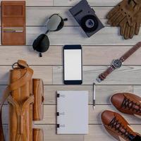 3D rendering of top view of traveler accessories on wooden background photo