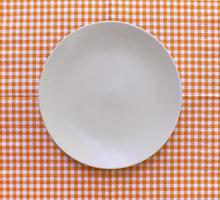 White plate on checkered tablecloth photo