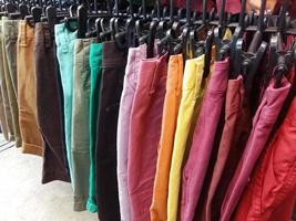 Colorful pants on hangers